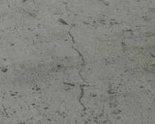 Vliesová tapeta do bytu beton 374291 z kolekce New Walls imituje béžovošedou betonovou omítku.